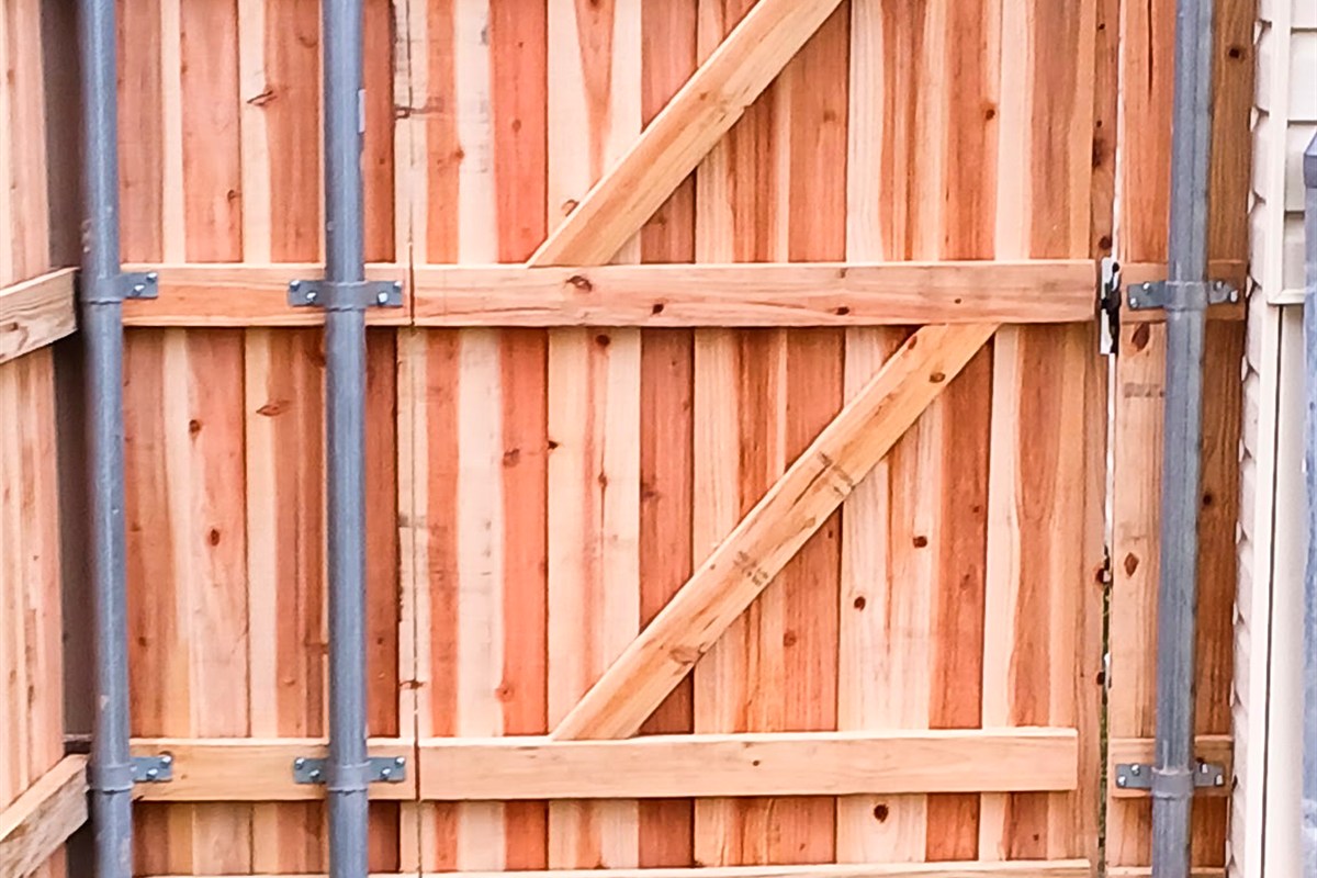 Custom cedar gate with full X-brace and steel posts