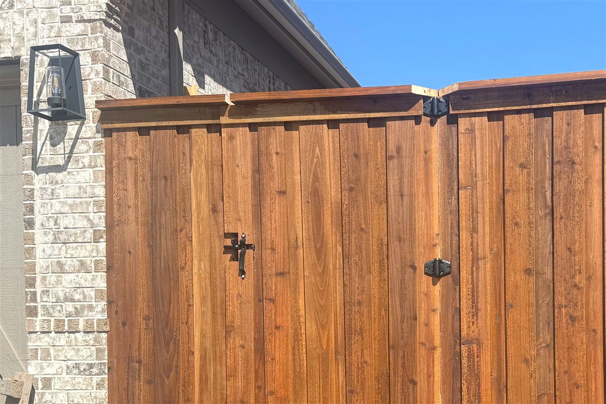 Double swing gate with cap board trim and black hardware