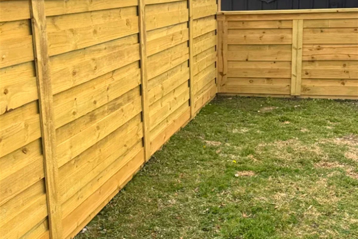 Horizontal board fence backyard corner
