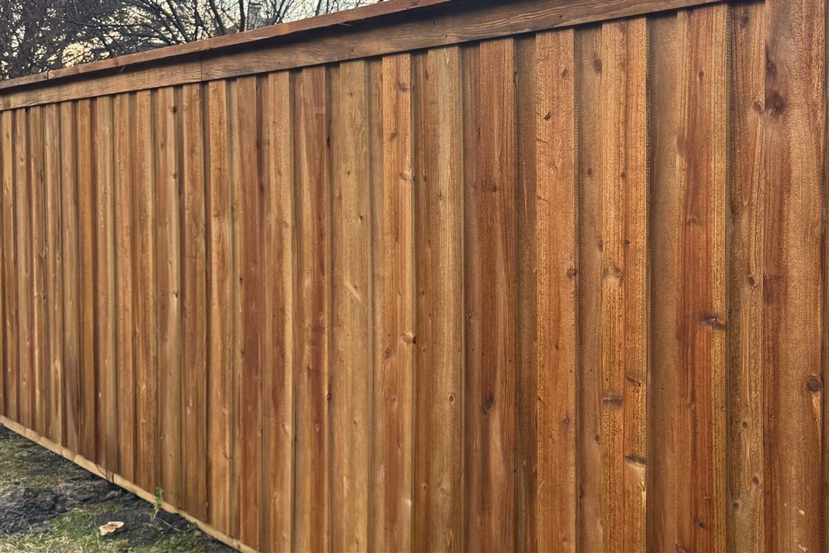 Privacy fence with flat cap board trim detail